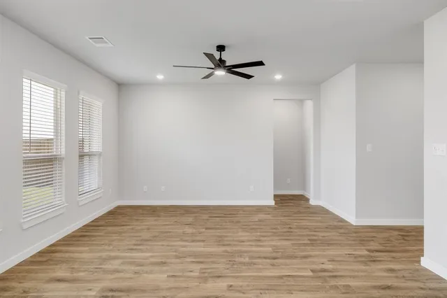 a kitchen with white cabinets appliances and a window