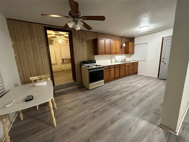 a large kitchen with a table and chairs