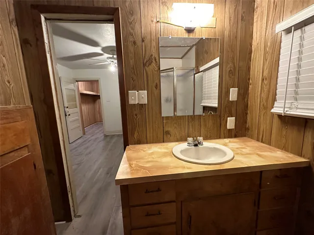 a bathroom with a sink a vanity and a mirror
