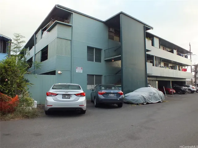 a car parked in front of a white building