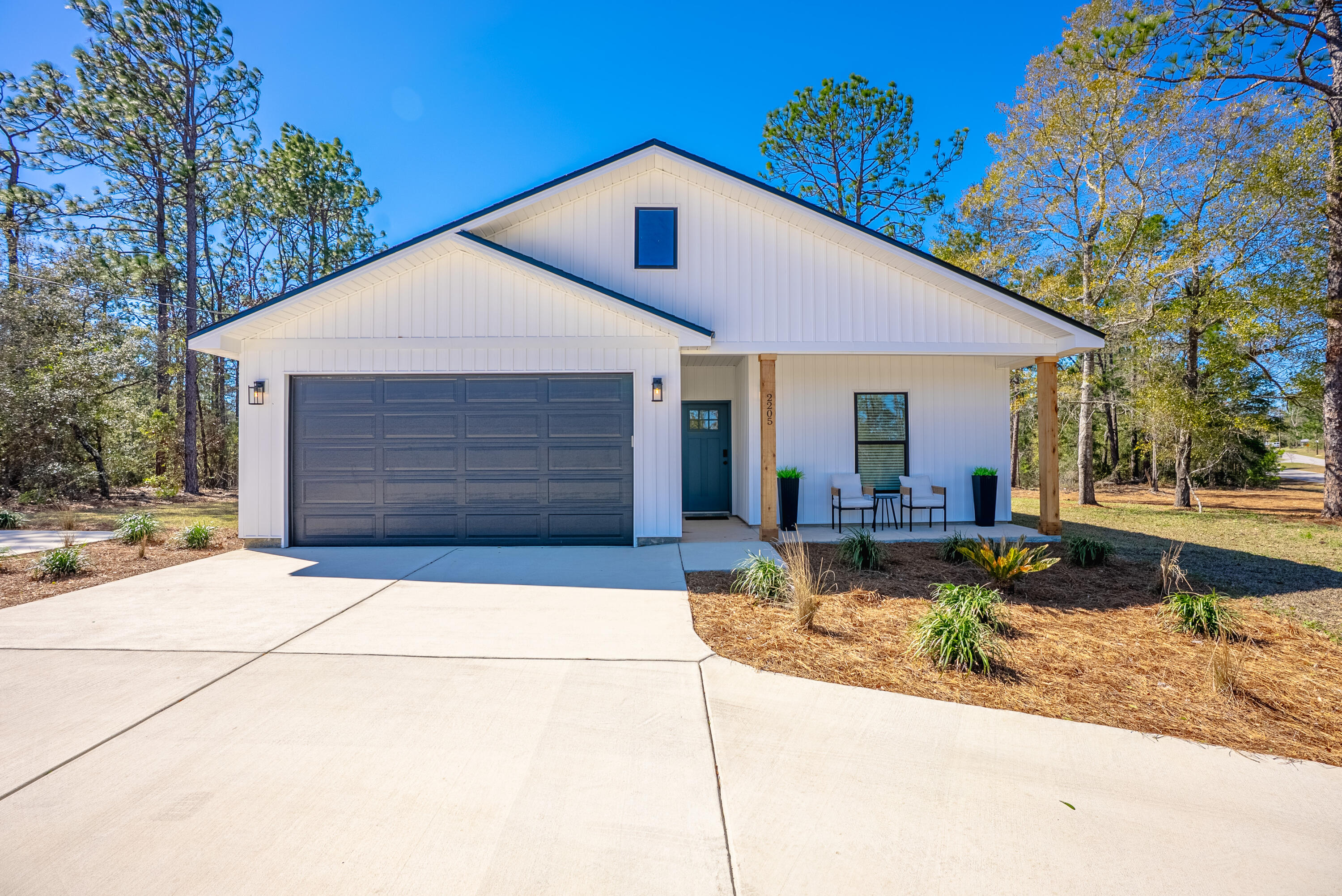 2021 Baldwin Street Chipley, FL 32428 - Photo 1 of 35 a front view of a house with garden