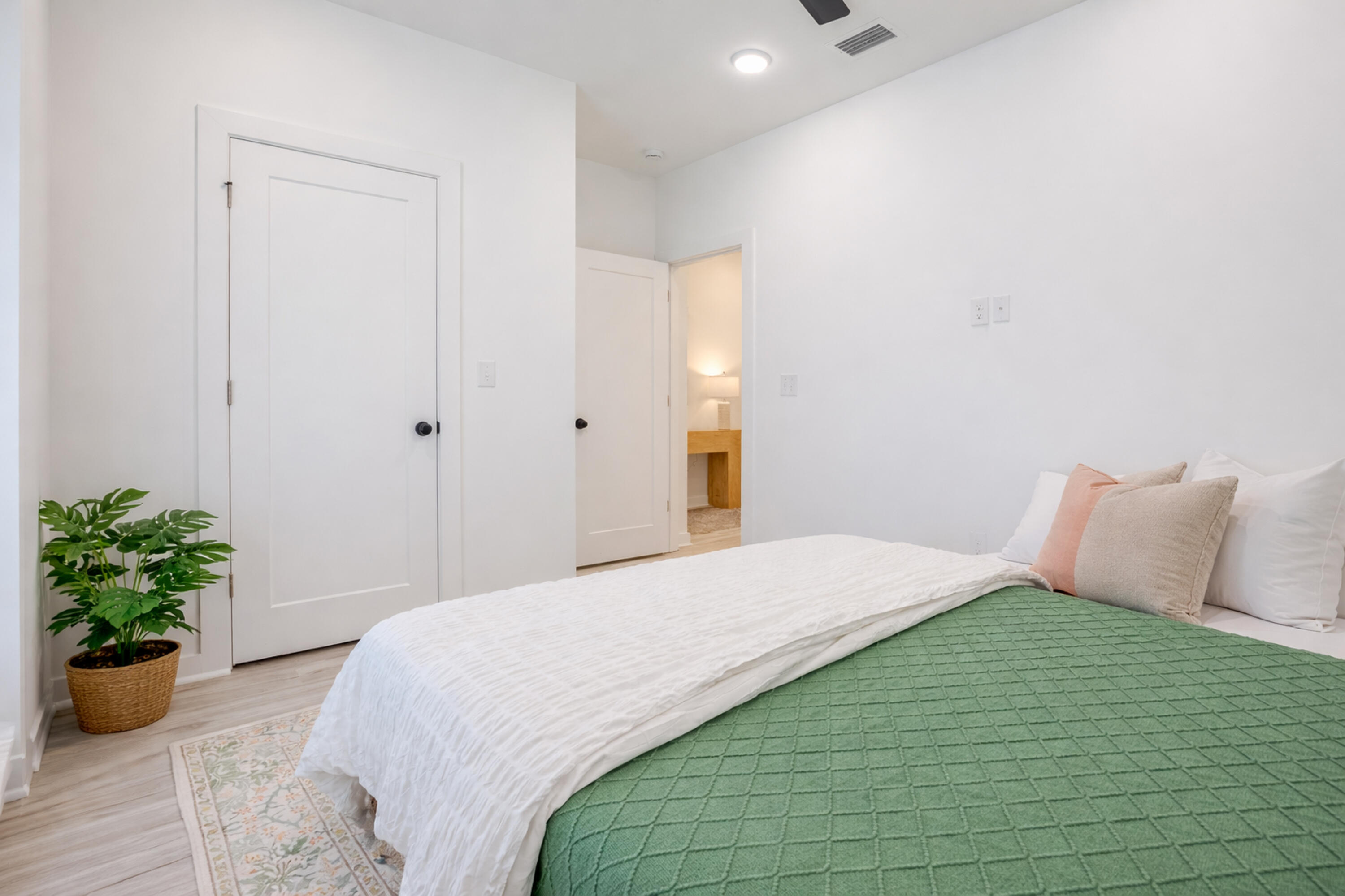 2021 Baldwin Street Chipley, FL 32428 - Photo 23 of 35 a bedroom with a bed and a potted plant