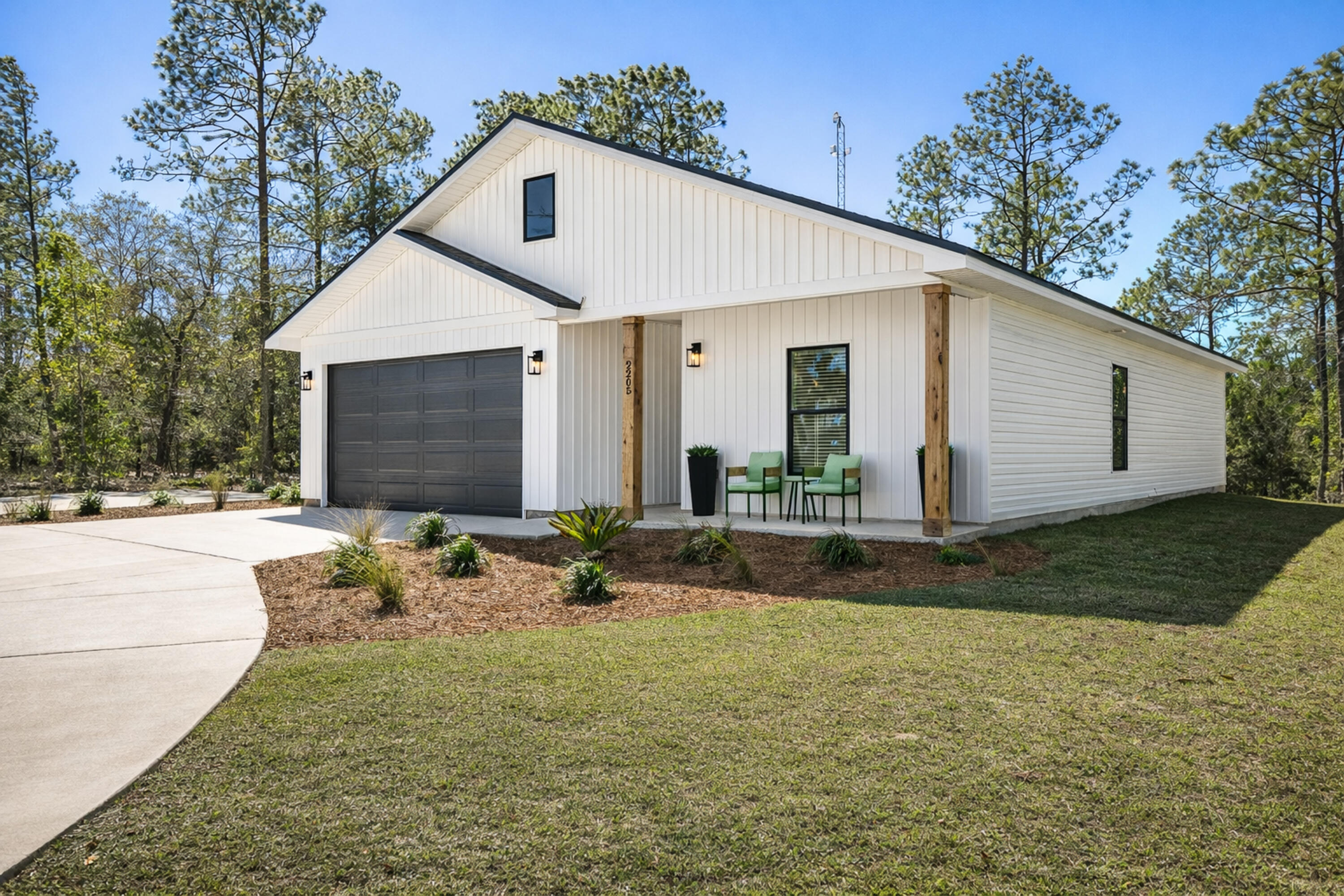 2021 Baldwin Street Chipley, FL 32428 - Photo 3 of 35 a view of a white house with yard and plants