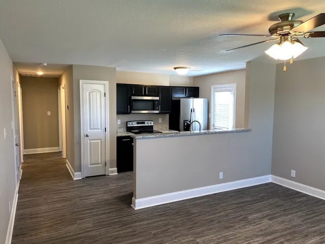 a view of kitchen with sink microwave and refrigerator
