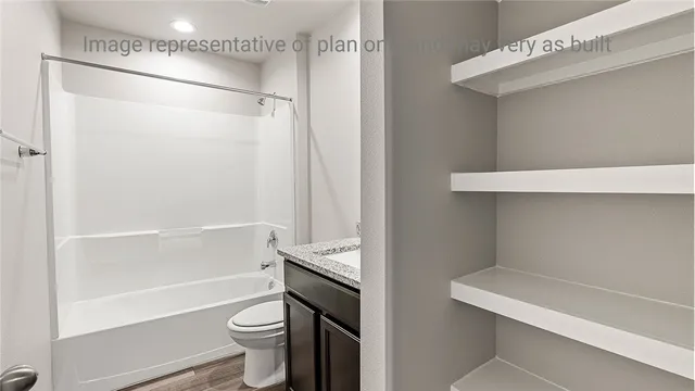 a bathroom with a shower a toilet and a sink