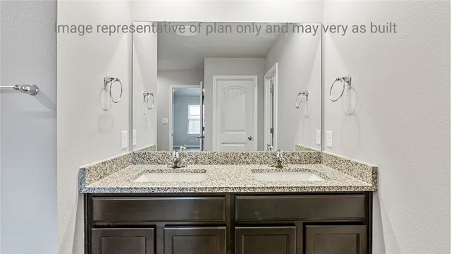 a bathroom with a granite countertop sink a mirror and a shower