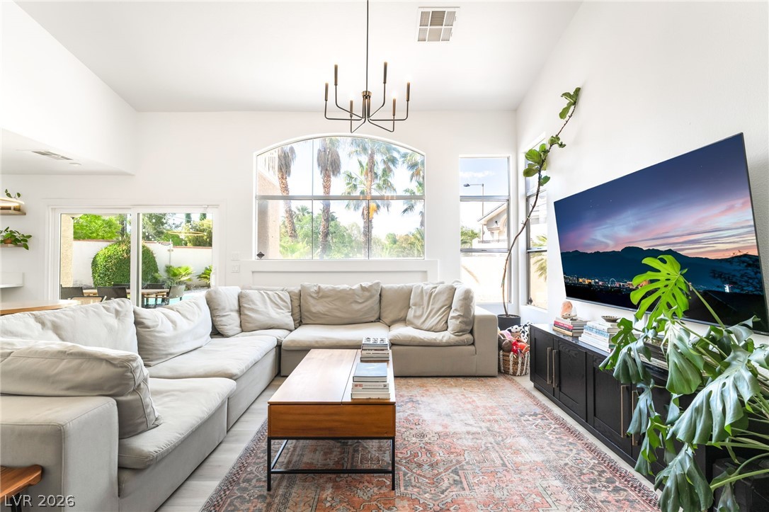 1941 Ivy Point Lane Las Vegas, NV 89134 - Photo 6 of 21 This living room features soaring ceilings, a large arched window, and a sliding glass door for abundant natural light.