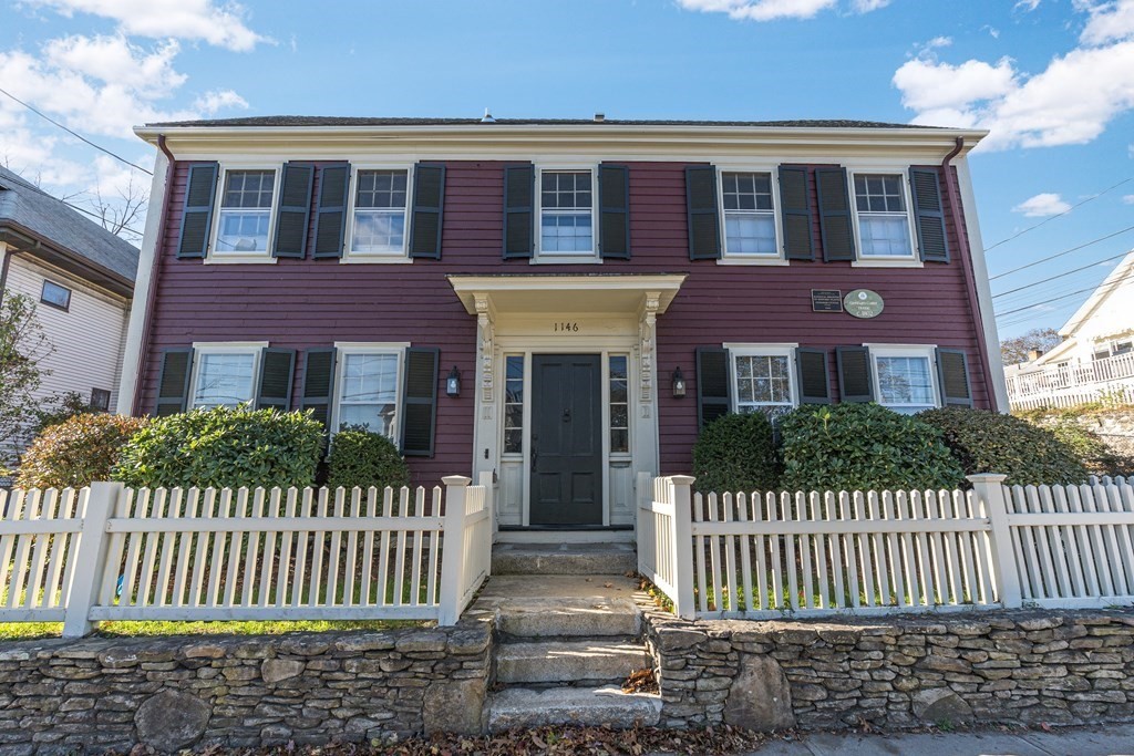 a front view of a house with a fence