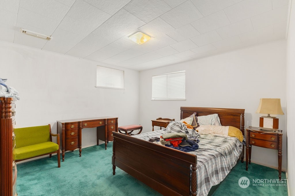 4215 Southwest Myrtle Street Seattle, WA 98136 - Photo 8 of 33 a bed room with a bed and a chair
