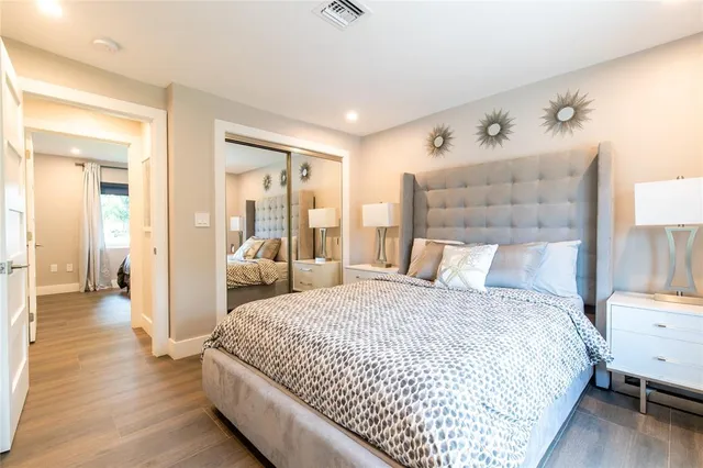 a bedroom with a bed and wooden floor