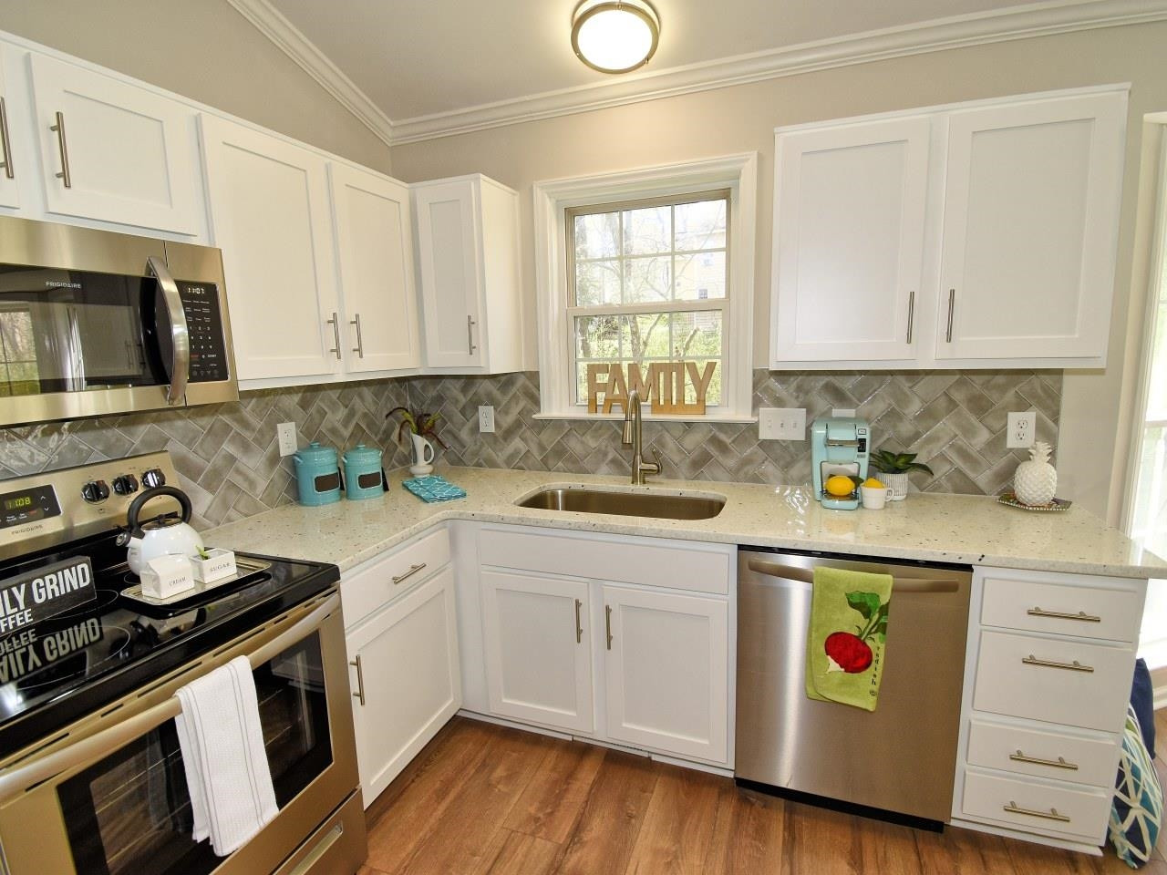 2201 Ruddy Road Raleigh, NC 27616 - Photo 11 of 27 a kitchen with stainless steel appliances granite countertop a sink and cabinets with wooden floors