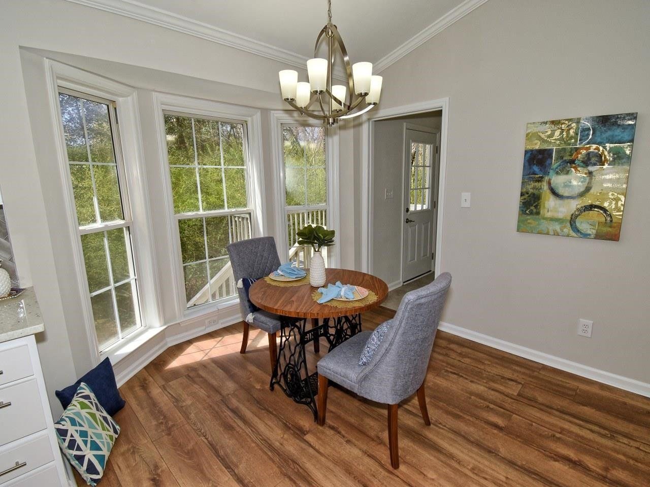 2201 Ruddy Road Raleigh, NC 27616 - Photo 8 of 27 a dining room with furniture a rug a potted plant and wooden floor