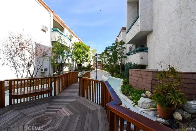 a view of balcony with wooden floor and fence