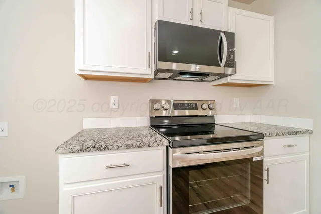 a kitchen with a stove and a microwave