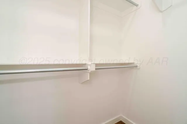 a view of a closet with racks on the wall