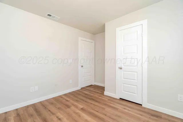 an empty room with wooden floor