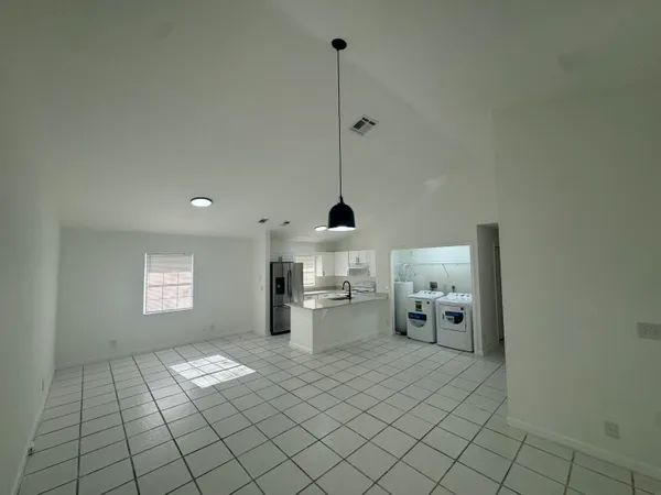 a kitchen with a sink and a stove top oven