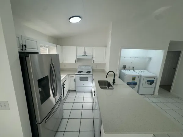 a view of hallway with washer and dryer