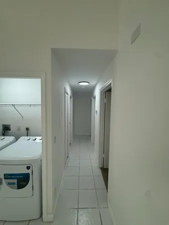 a kitchen with refrigerator and cabinets