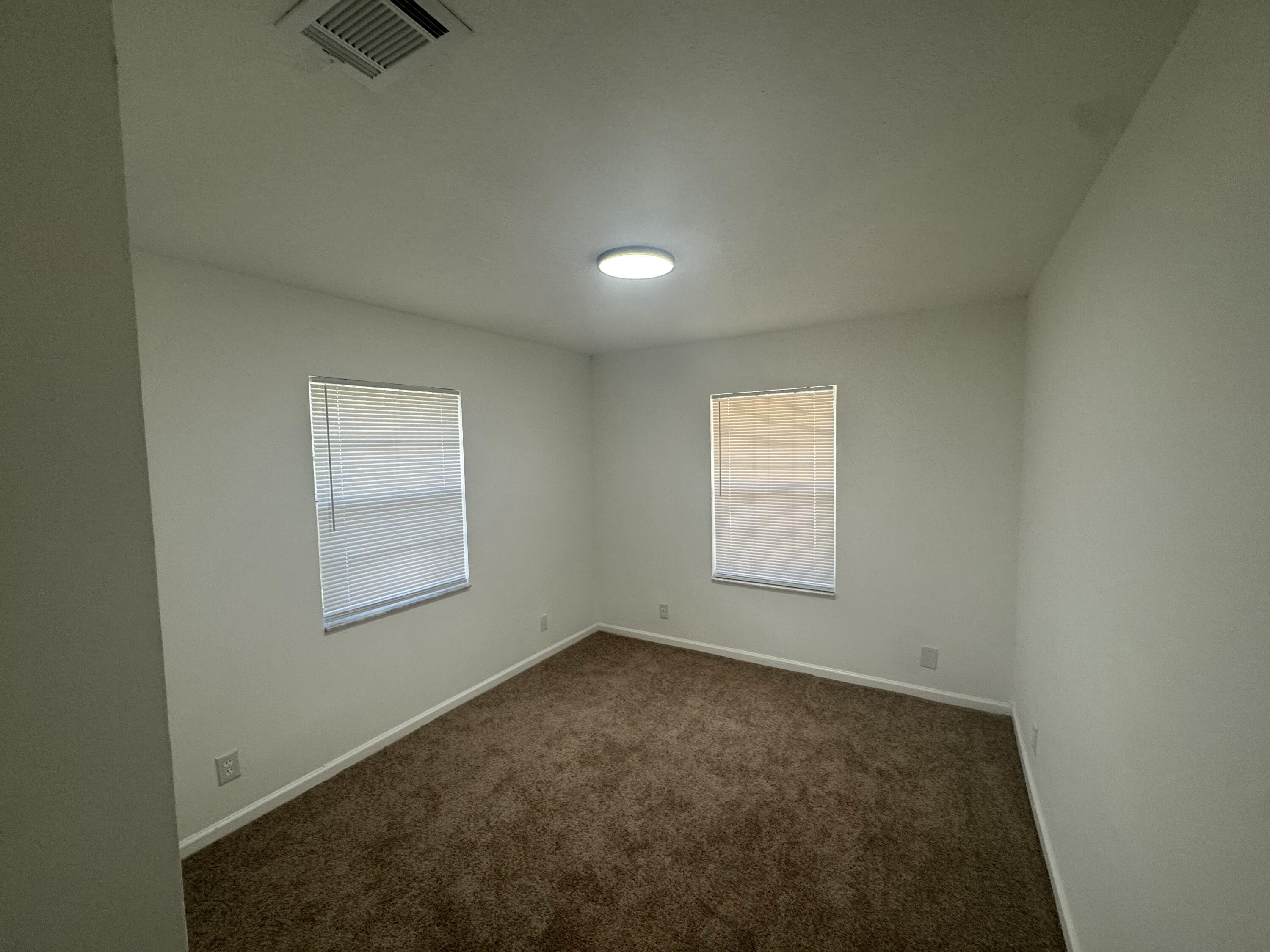 1046 Goldenrod Road, Unit 1048 Wellington, FL 33414 - Photo 10 of 10 an empty room with a empty space and windows