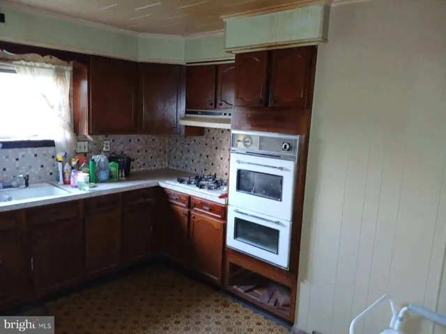 a kitchen with stainless steel appliances granite countertop a sink stove and microwave