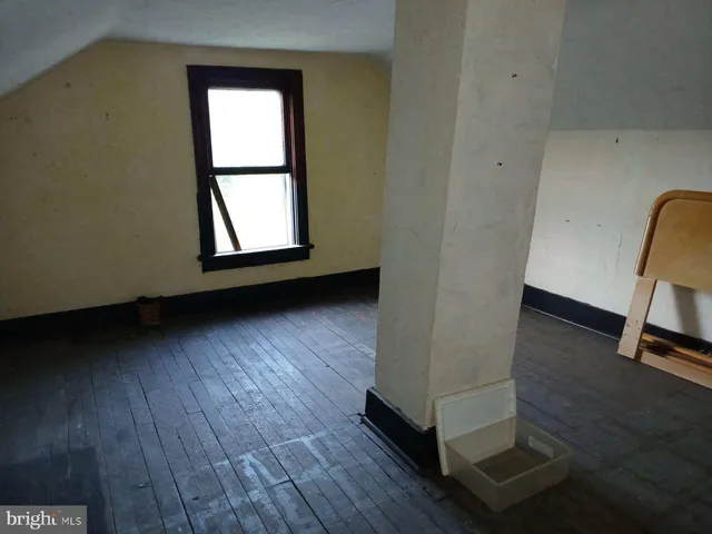 a view of a room with wooden floor and window
