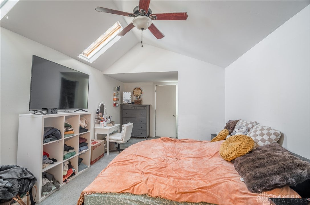 220 Racer Street Troy, OH 45373 - Photo 21 of 33 This airy bedroom features vaulted ceilings and a skylight, creating a bright and open atmosphere.