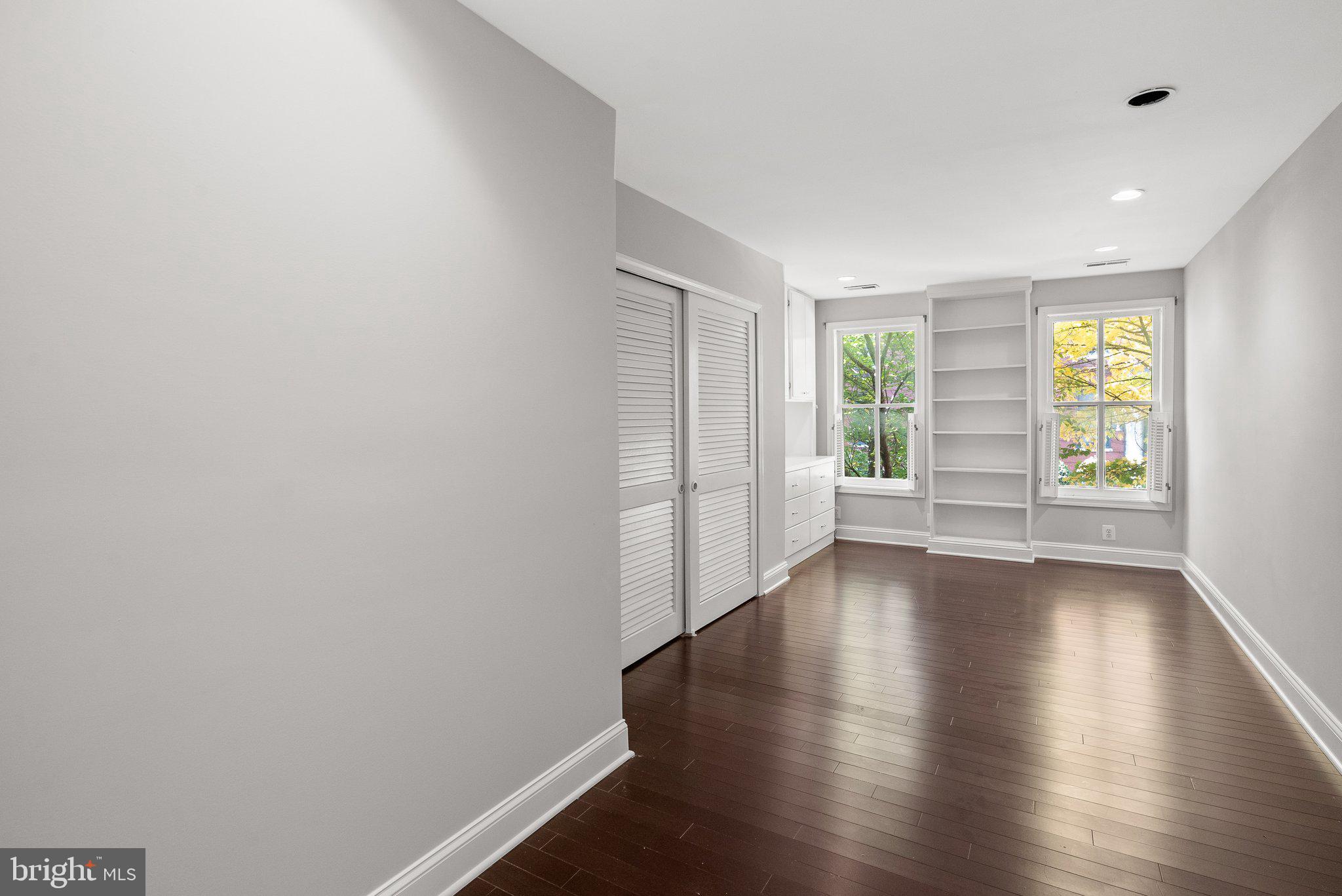 1257 35th Street Northwest Washington, DC 20007 - Photo 12 of 21 an empty room with wooden floor and windows