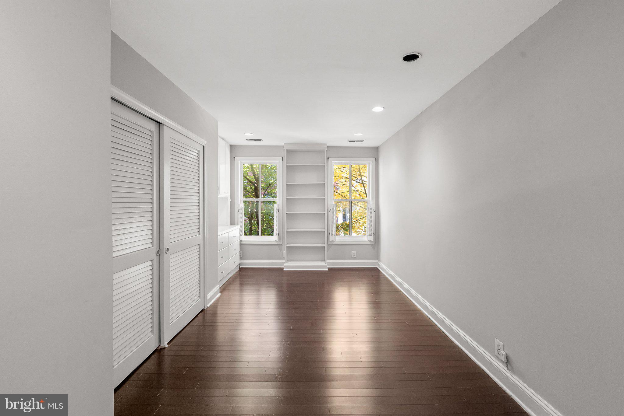 1257 35th Street Northwest Washington, DC 20007 - Photo 13 of 21 a view of an empty room with wooden floor and a window