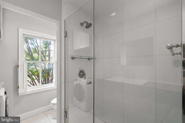 a bathroom with a shower and a window