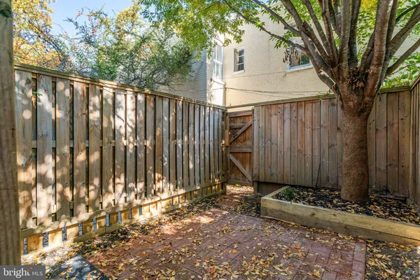 a view of a house with a wooden fence