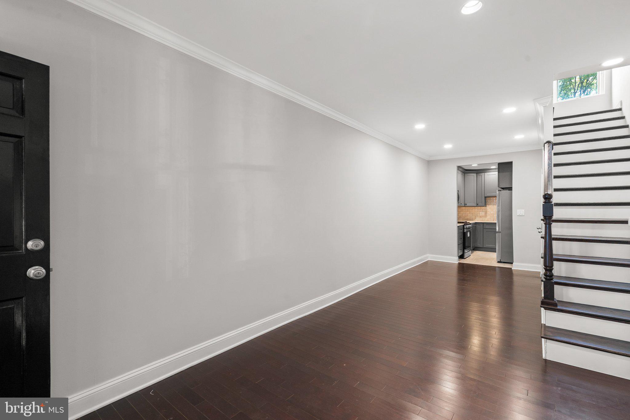 1257 35th Street Northwest Washington, DC 20007 - Photo 4 of 21 a view of an empty room with wooden floor and a window