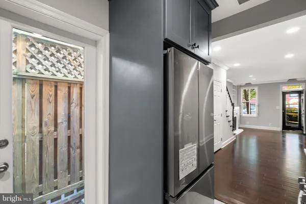 a view of a hallway with wooden floor and staircase