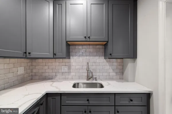 a kitchen with a sink and cabinets