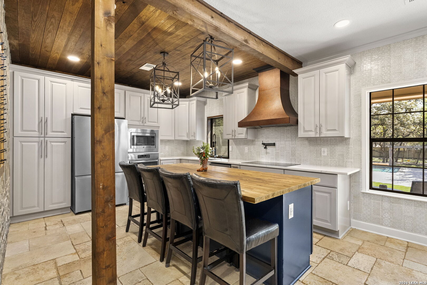 10918 Hunters Way Helotes, TX 78023 - Photo 16 of 49 a kitchen with stainless steel appliances granite countertop a table chairs sink and cabinets