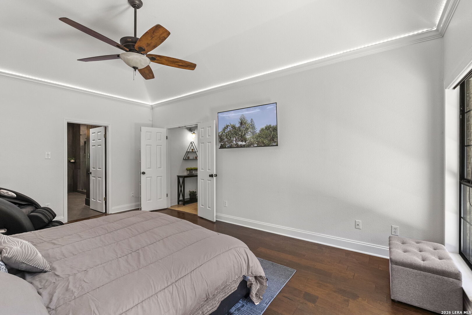 10918 Hunters Way Helotes, TX 78023 - Photo 21 of 49 a bedroom with a bed and a chandelier