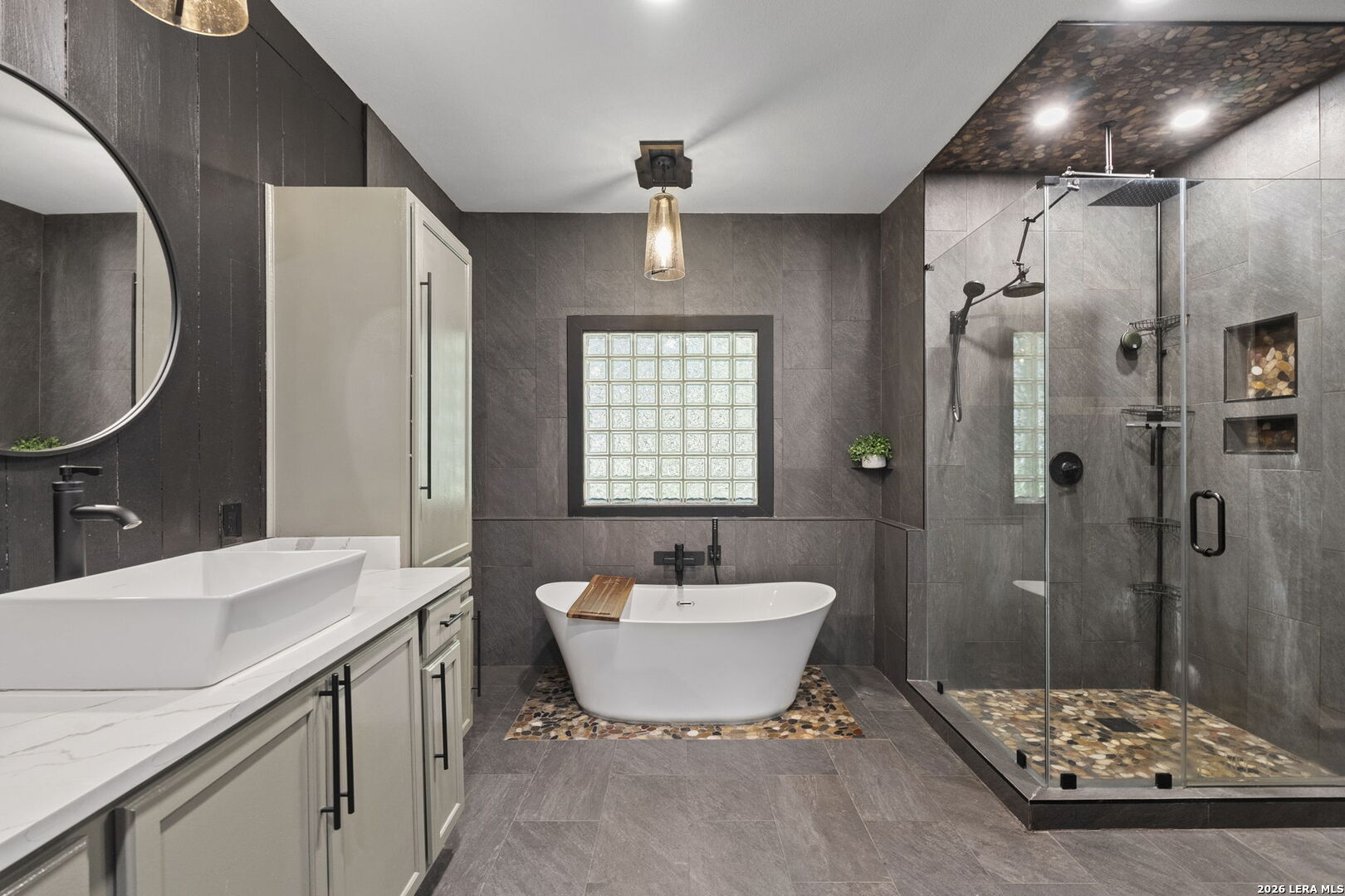 10918 Hunters Way Helotes, TX 78023 - Photo 23 of 49 a bathroom with a sink a toilet and shower