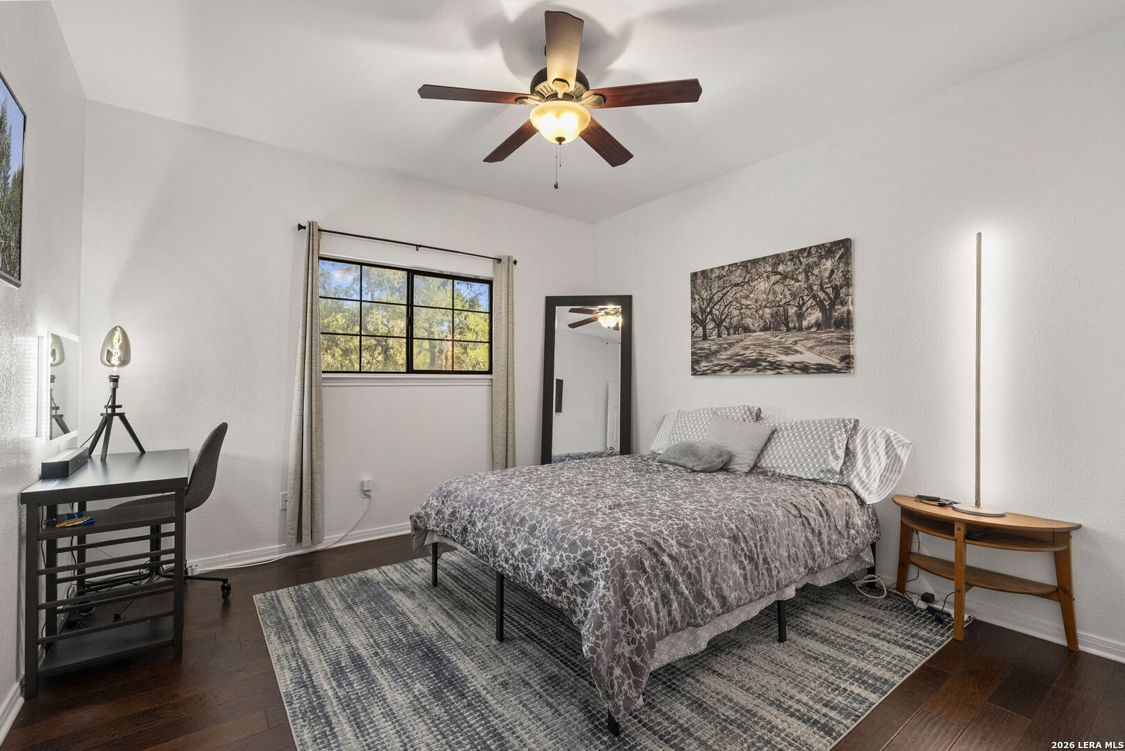 10918 Hunters Way Helotes, TX 78023 - Photo 30 of 49 a bedroom with a bed and a chandelier