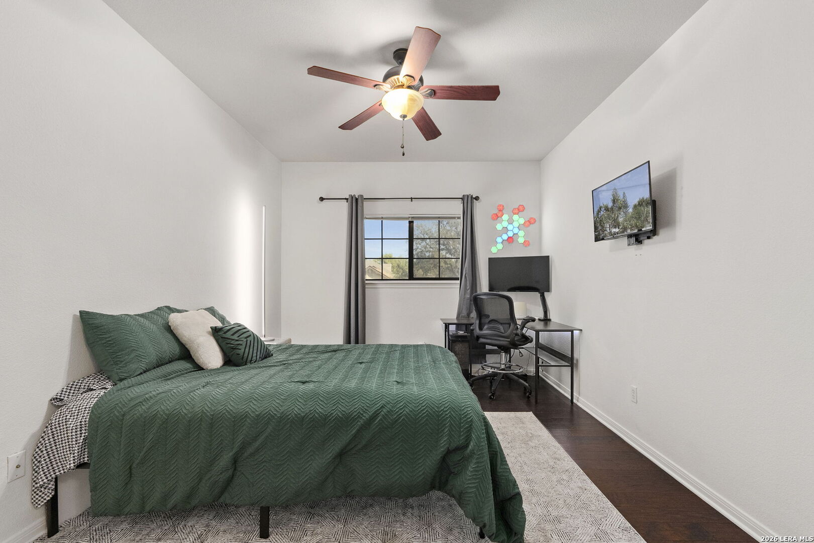 10918 Hunters Way Helotes, TX 78023 - Photo 33 of 49 a bedroom with a bed window and a flat screen tv