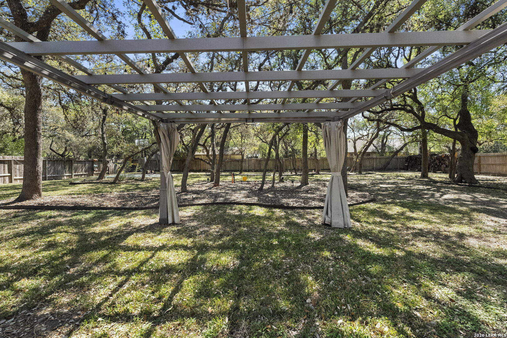 10918 Hunters Way Helotes, TX 78023 - Photo 40 of 49 a view of a yard with wooden fence