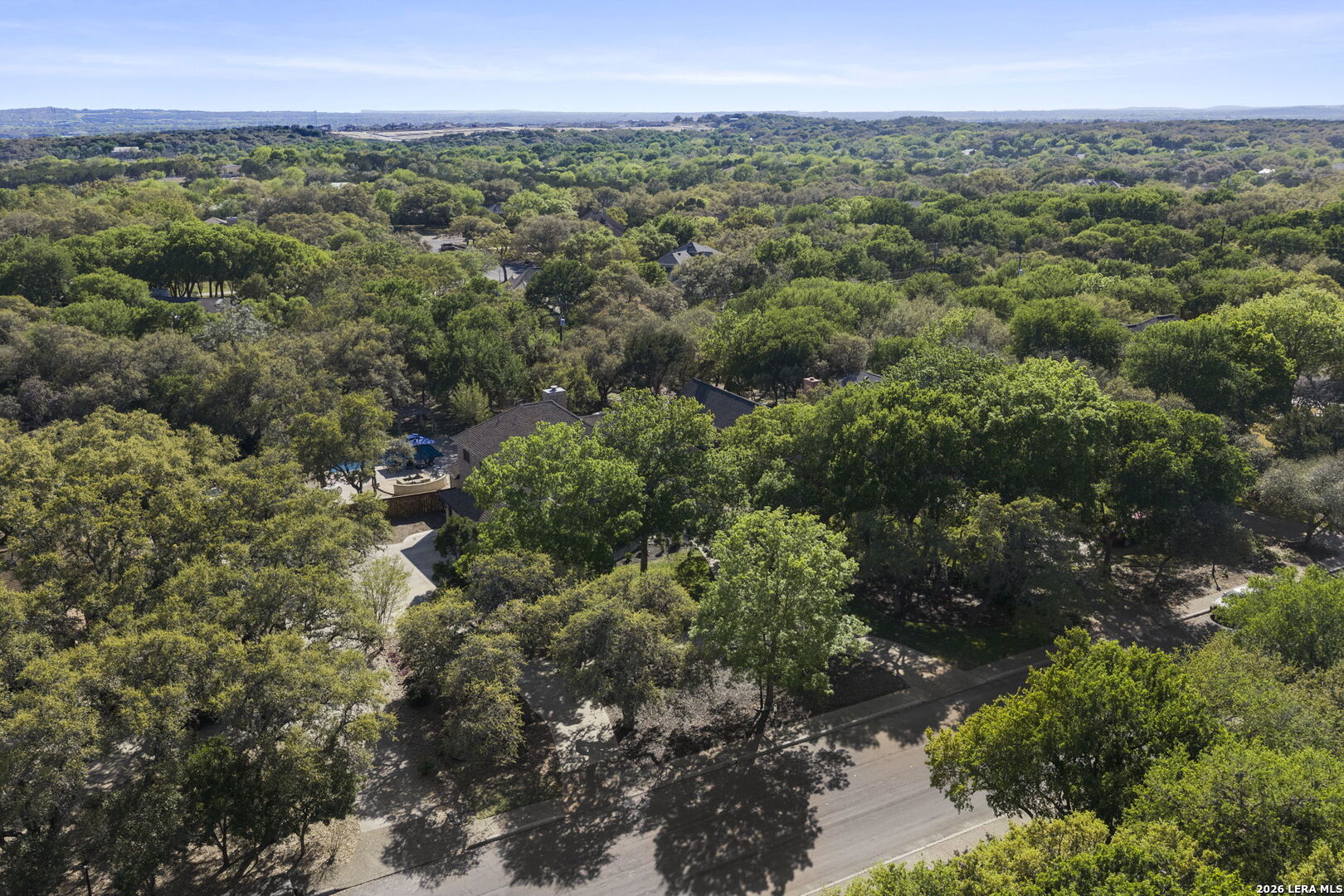10918 Hunters Way Helotes, TX 78023 - Photo 48 of 49 a view of a green field with lots of bushes