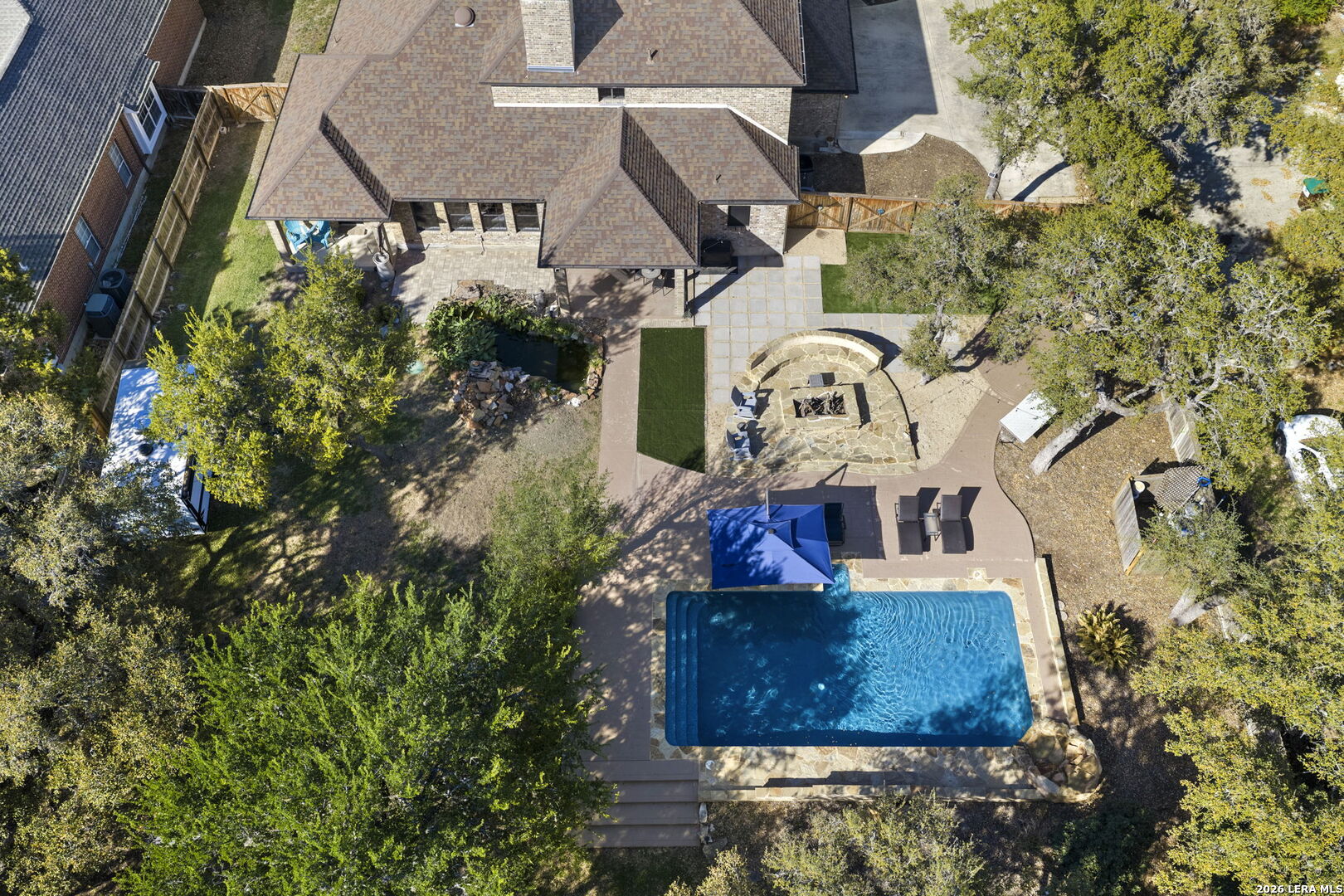 10918 Hunters Way Helotes, TX 78023 - Photo 5 of 49 an aerial view of a house with a yard and sitting area