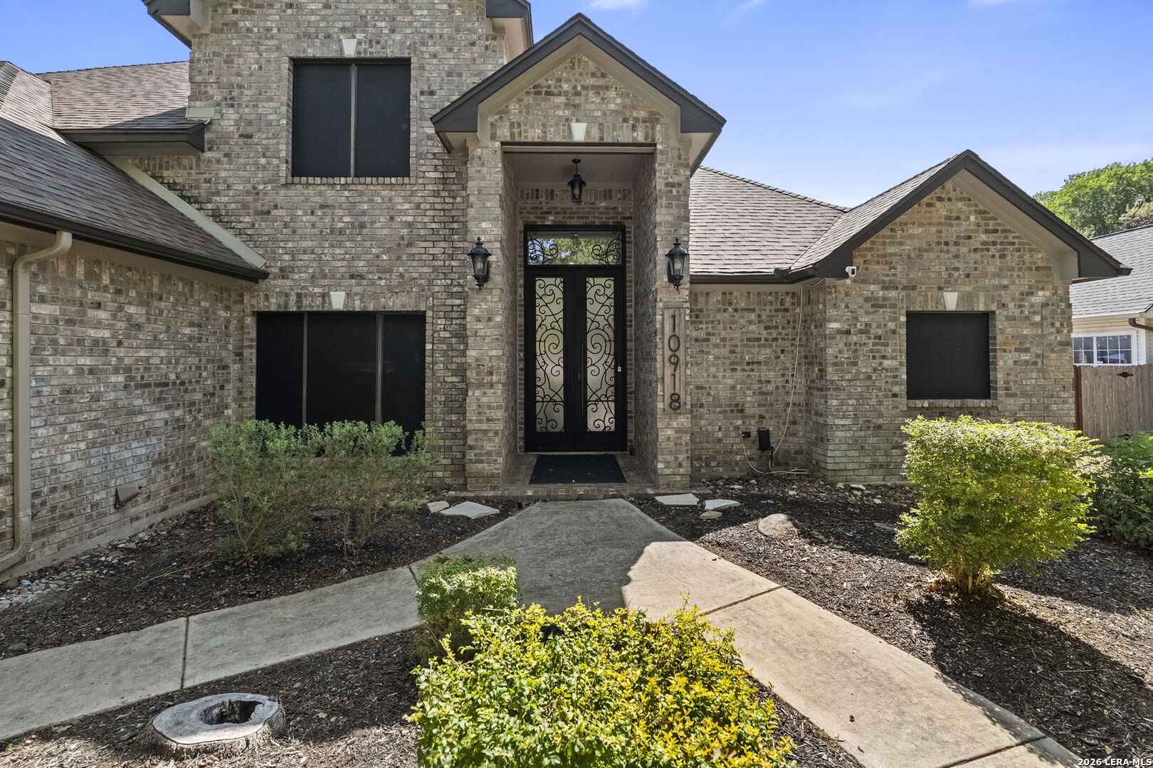 10918 Hunters Way Helotes, TX 78023 - Photo 9 of 49 a front view of a house with a yard