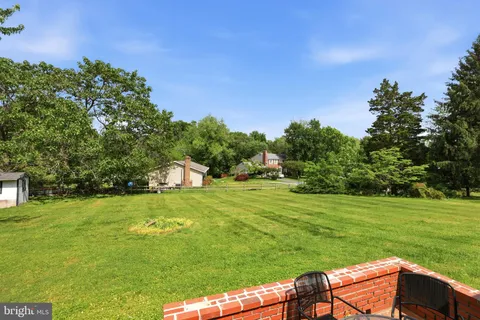 a view of a big yard with a house in the background