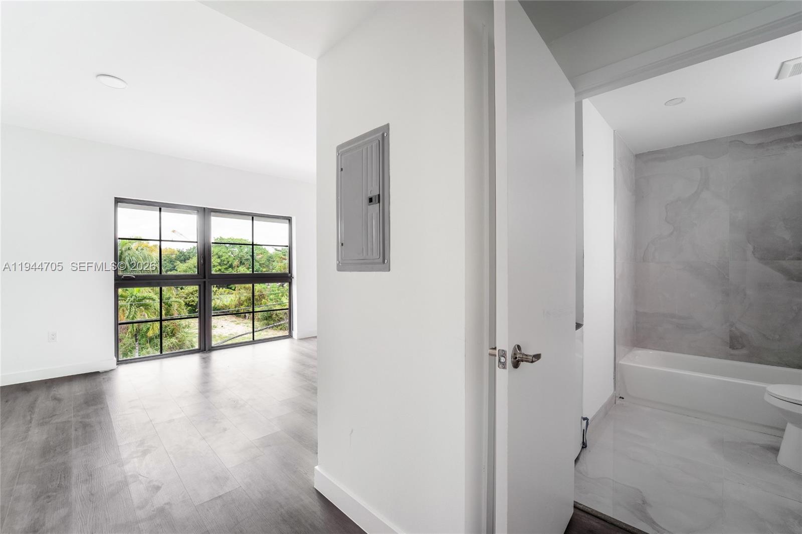 1165 Northwest 8th Avenue, Unit 101 Miami, FL 33136 - Photo 7 of 9 a view of an empty room with a window