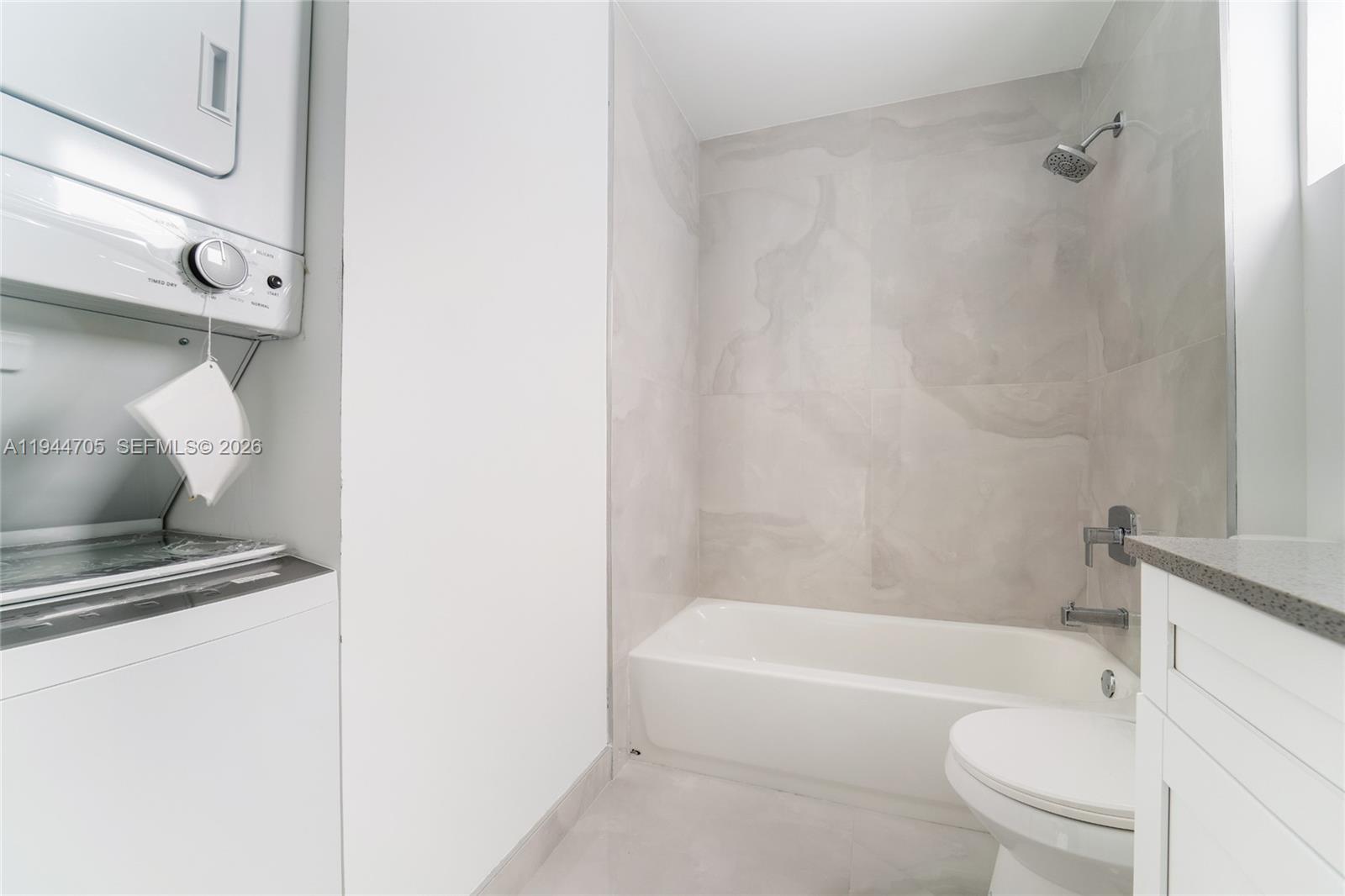 1165 Northwest 8th Avenue, Unit 101 Miami, FL 33136 - Photo 9 of 9 a bathroom with a bathtub and a toilet