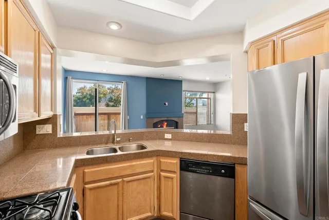 a kitchen with a refrigerator a sink and a window
