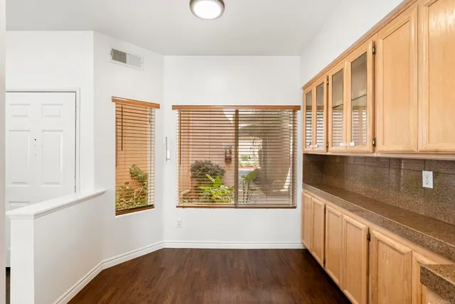 a view of a kitchen with a window and wooden floor