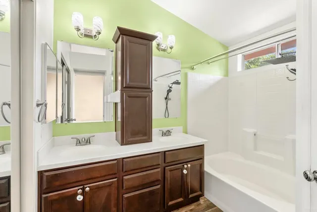 a bathroom with a double vanity sink and mirror