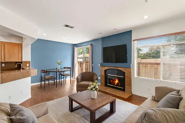 a living room with furniture flat screen tv and a fireplace